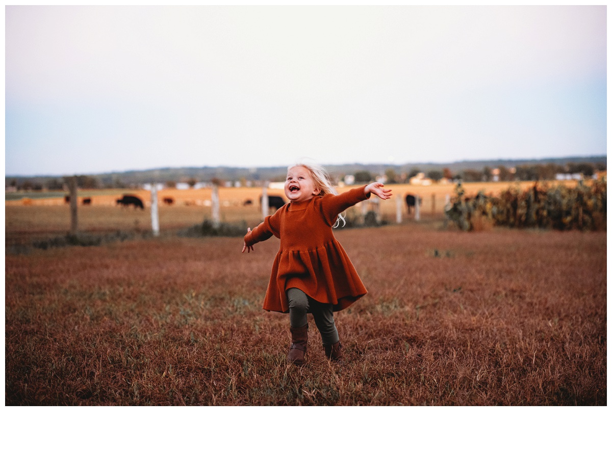 toddler girl on a farm running free