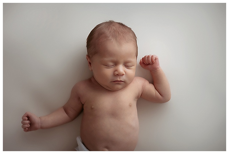 newborn baby on cream backdrop baby led photo session in Centerville, MD