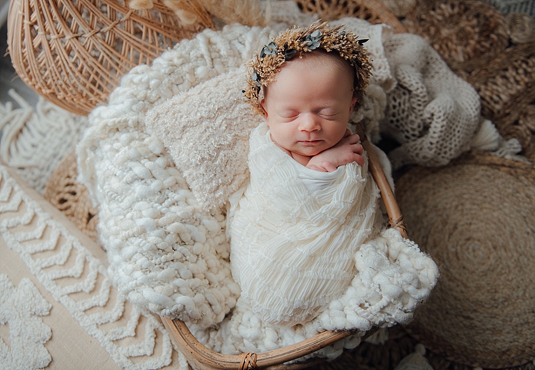 boho baby in basket wearing cream colors for Maryland newborn photography session