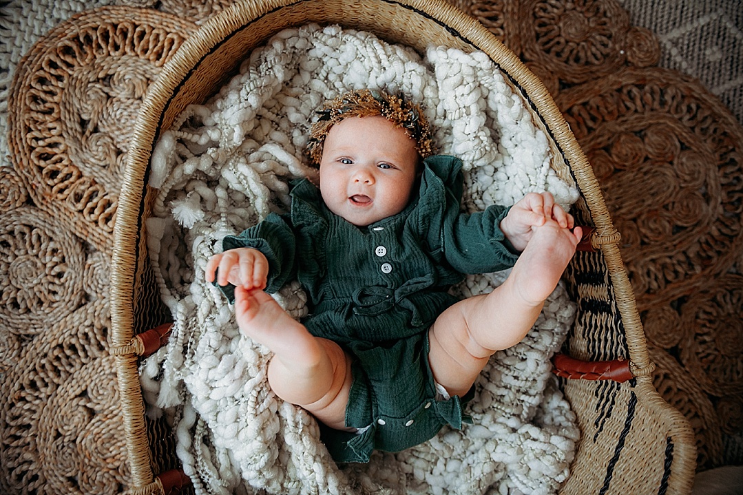 baby girl wearing green in Moses basket for Annapolis Photo session