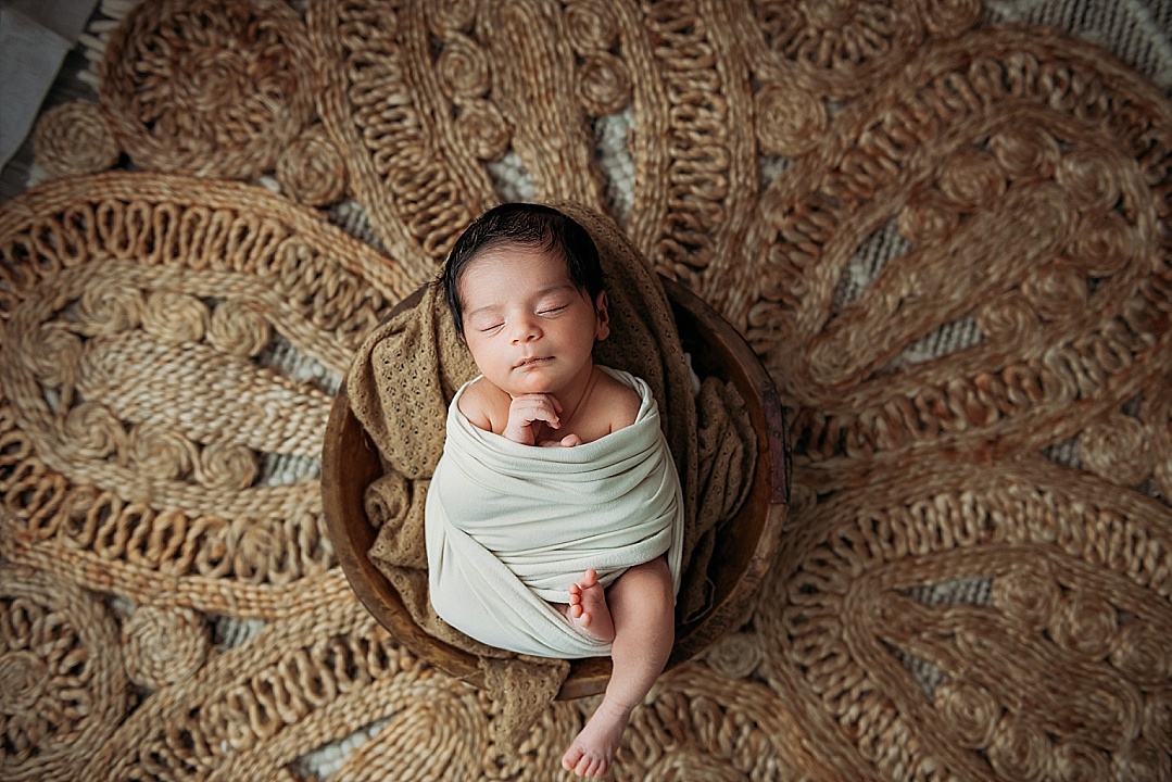 boho new baby in bowl with neutral colors for Annapolis newborn photography sesison