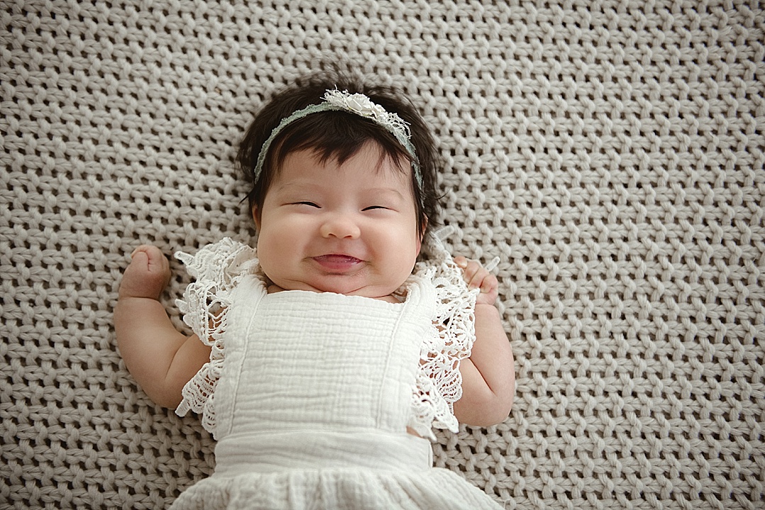 older happy baby in neutral boho dress for Maryland photography session