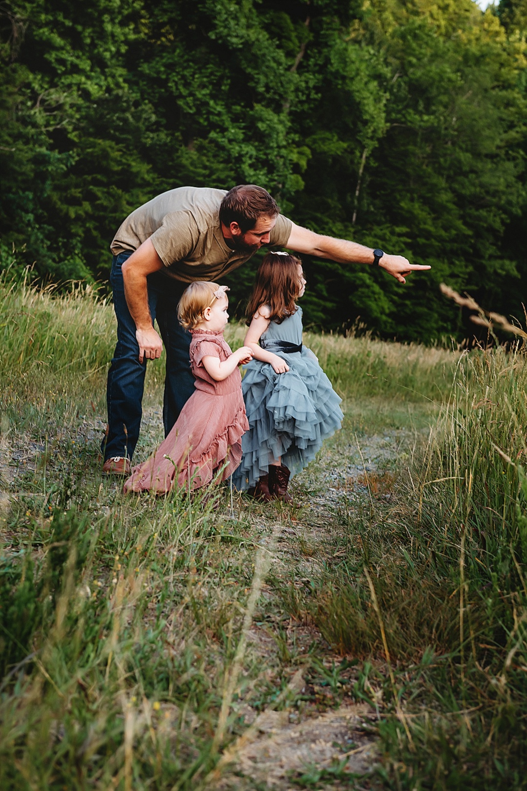 dad and girls exploring a path for family photos pink and blue dress for imaginative play