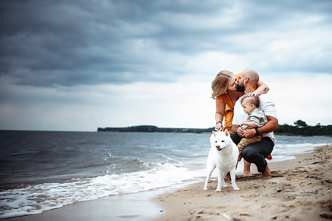 family with dog on Annapolis beach in rain
