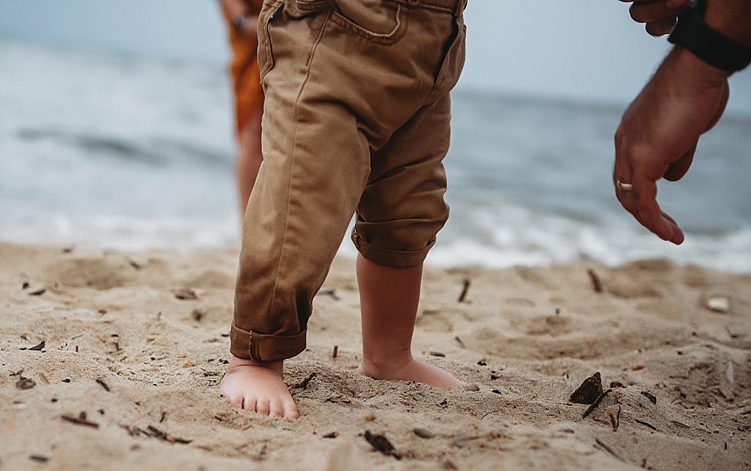 baby boy feet in sand