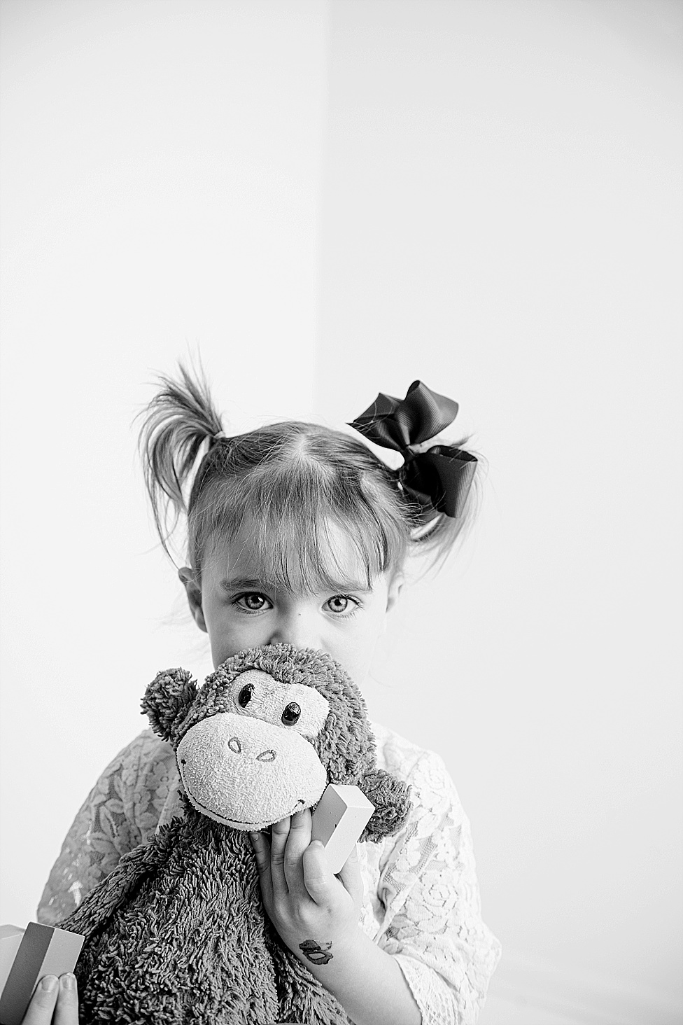 black and white photo pigtails with stuffed animal