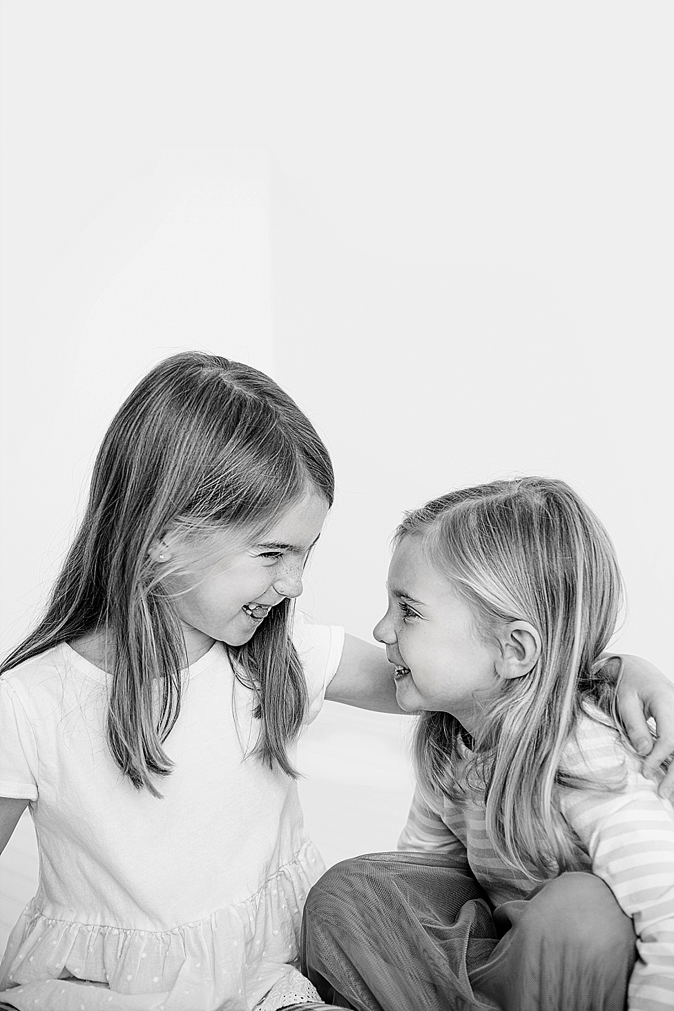 black and white photo sisters giggling in Annapolis studio