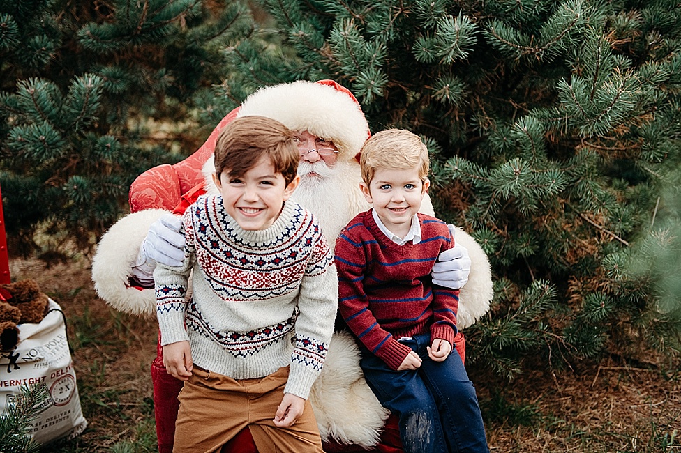 little boys in sweaters sitting on Santa's lap in Maryland Tree farm