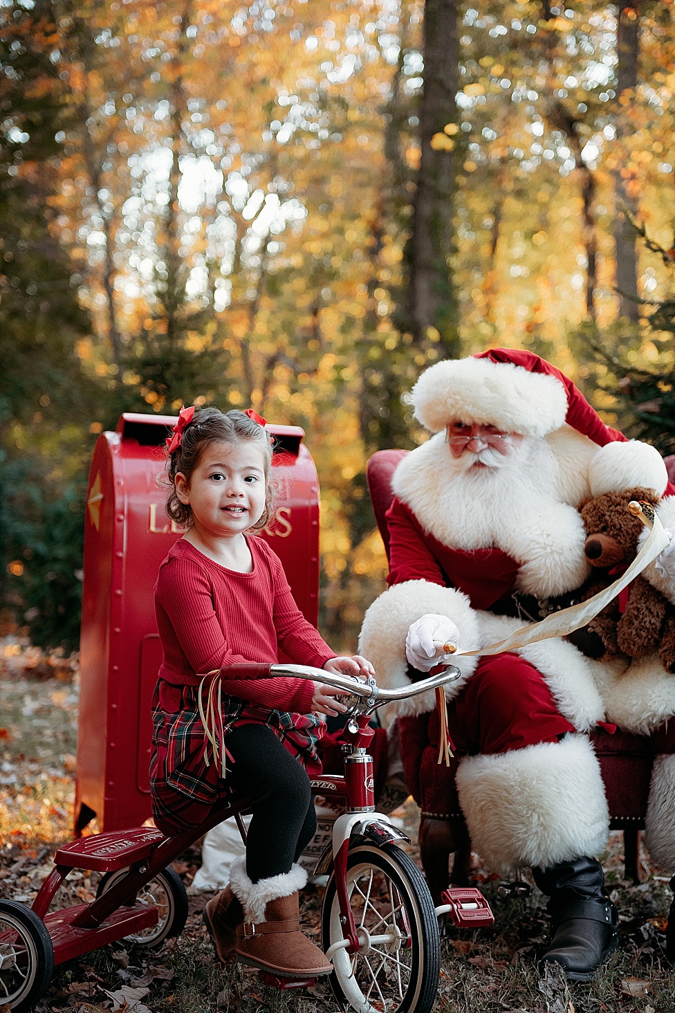 little girl on red tricycle to meet Santa in Annapolis Maryland